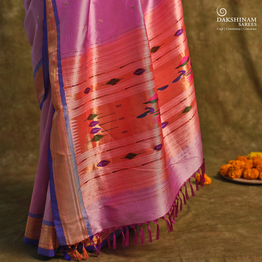 Lavender Paithani silk saree with gold zari paisley buttas, blue selvedge border with mayil motifs and traditional peacock pallu.