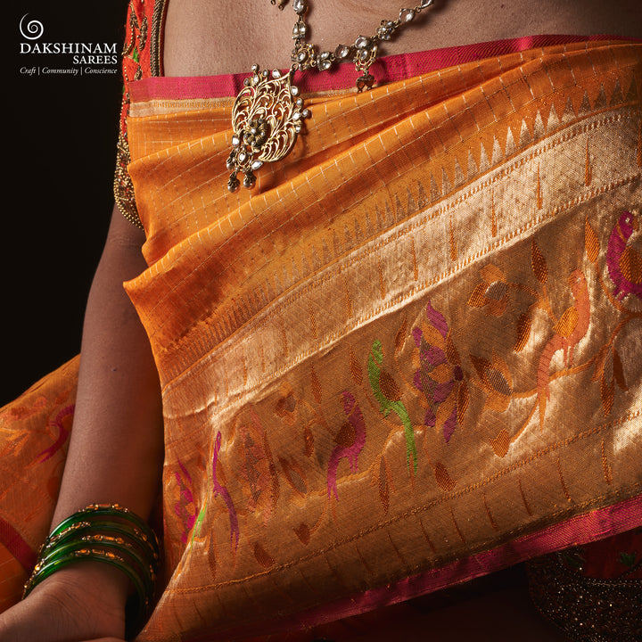 Orange Kanjivaram silk saree with checkered body, Paithani lotus vine and parrot border, pink selvedge and traditional pallu.