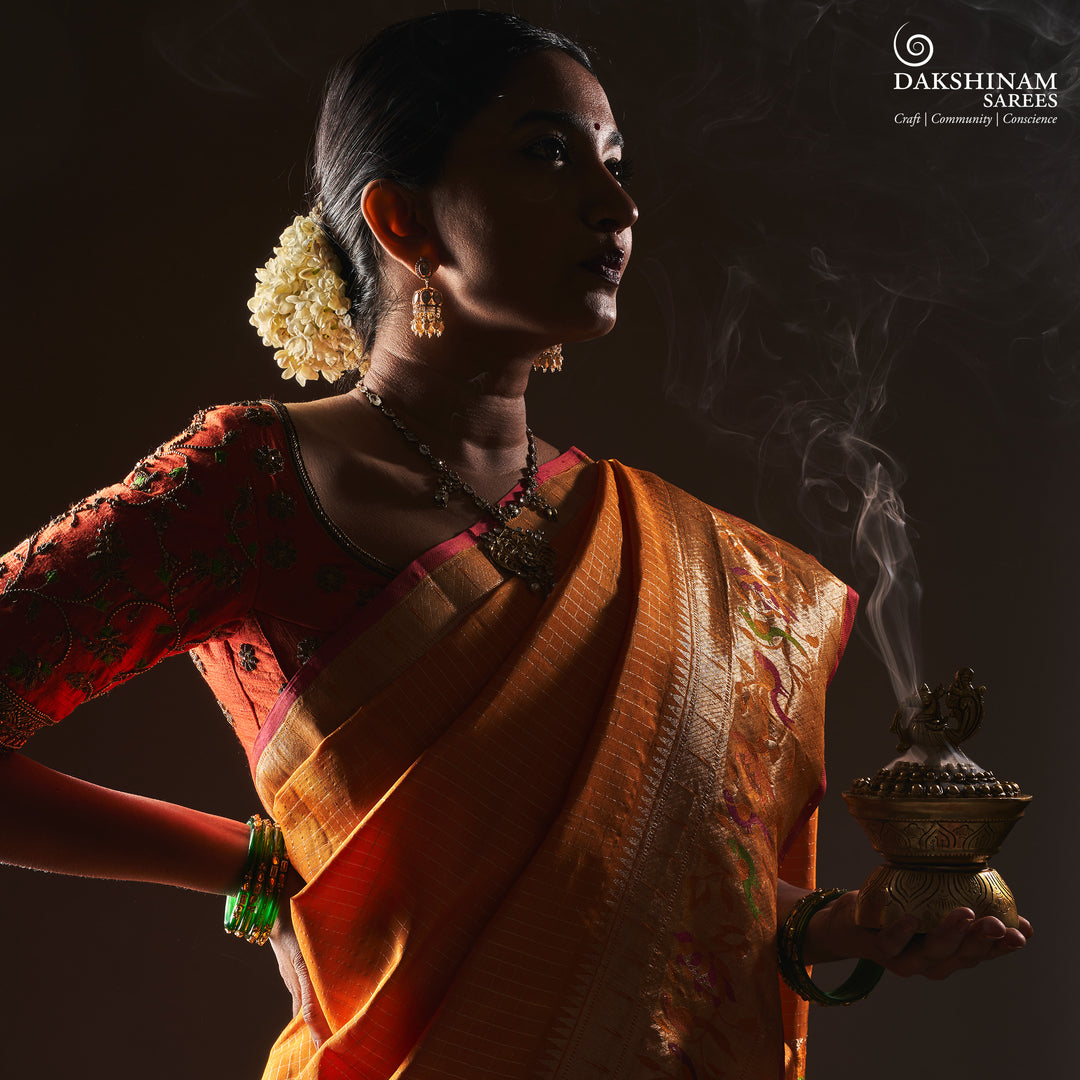 Orange Kanjivaram silk saree with checkered body, Paithani lotus vine and parrot border, pink selvedge and traditional pallu.