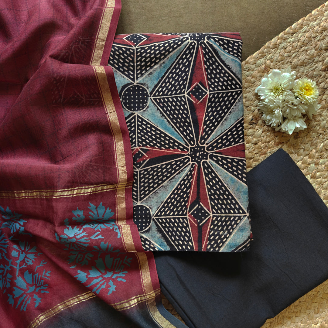 Black Ajrakh printed cotton 3-piece suit set with star motifs, plain black bottom and Chanderi floral dupatta