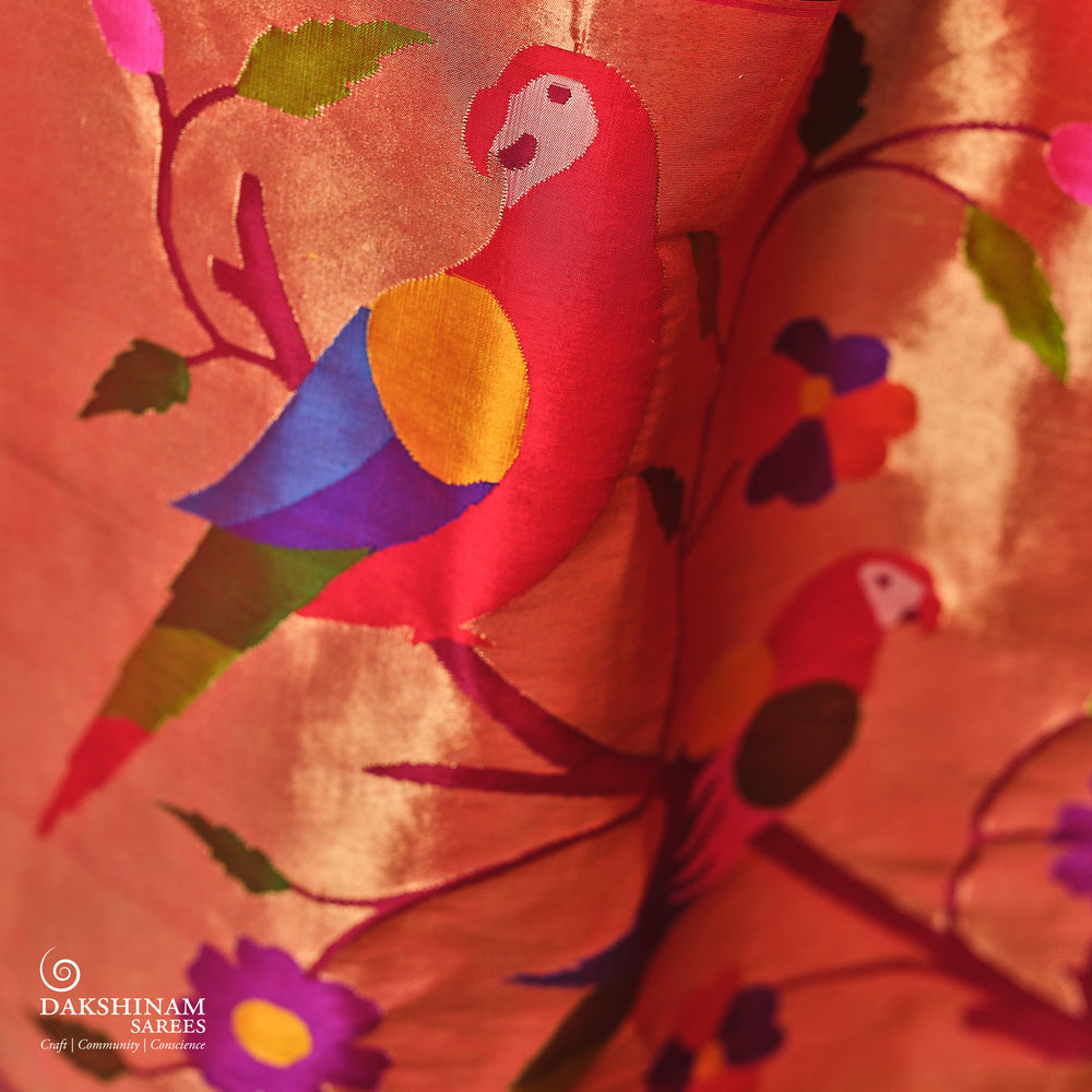 Pink Paithani silk saree with gold zari dotted body, tissue border with Munia motifs and multicolor parrot pallu.