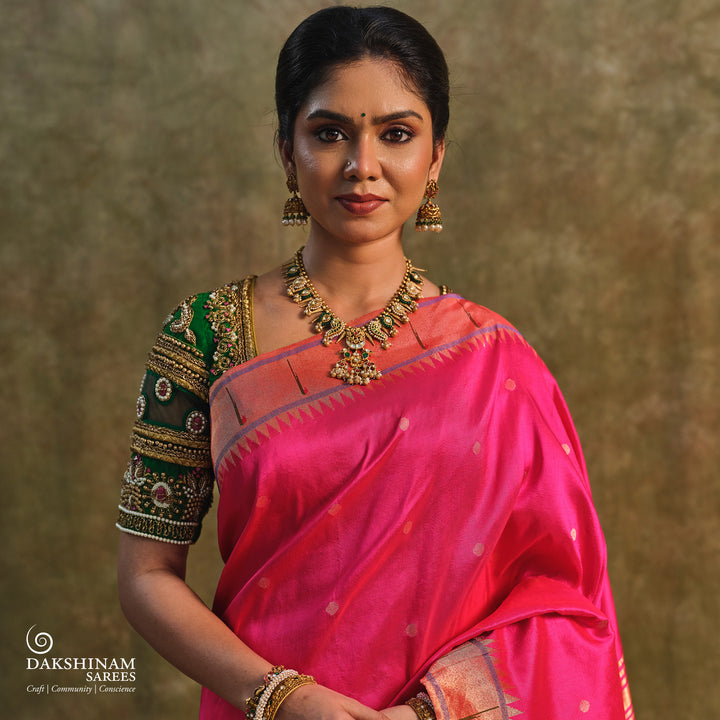 Pink Paithani silk saree with gold zari dotted body, tissue border with Munia motifs and multicolor parrot pallu.