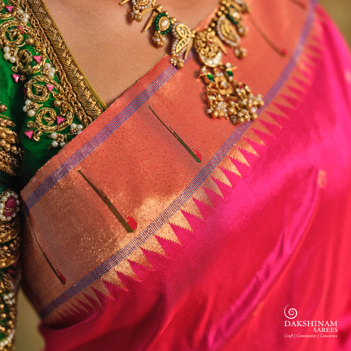 Pink Paithani silk saree with gold zari dotted body, tissue border with Munia motifs and multicolor parrot pallu.