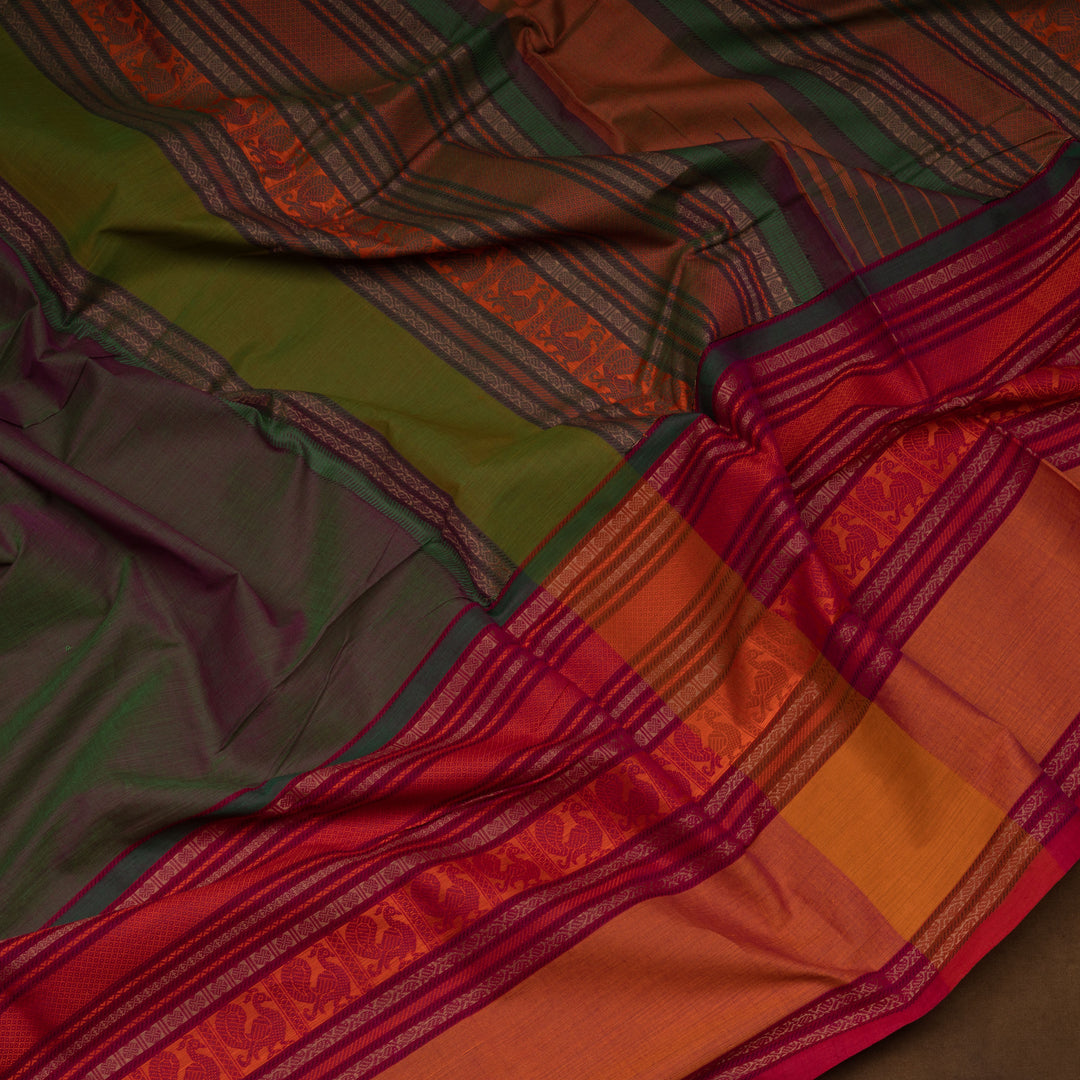 Green handwoven cotton saree with orange and brown border, peacock motifs and traditional pallu