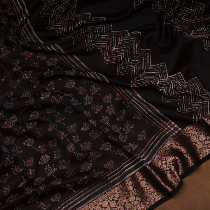 Black Chanderi silk cotton saree with white lotus floral print, gold zari border and orange striped pallu
