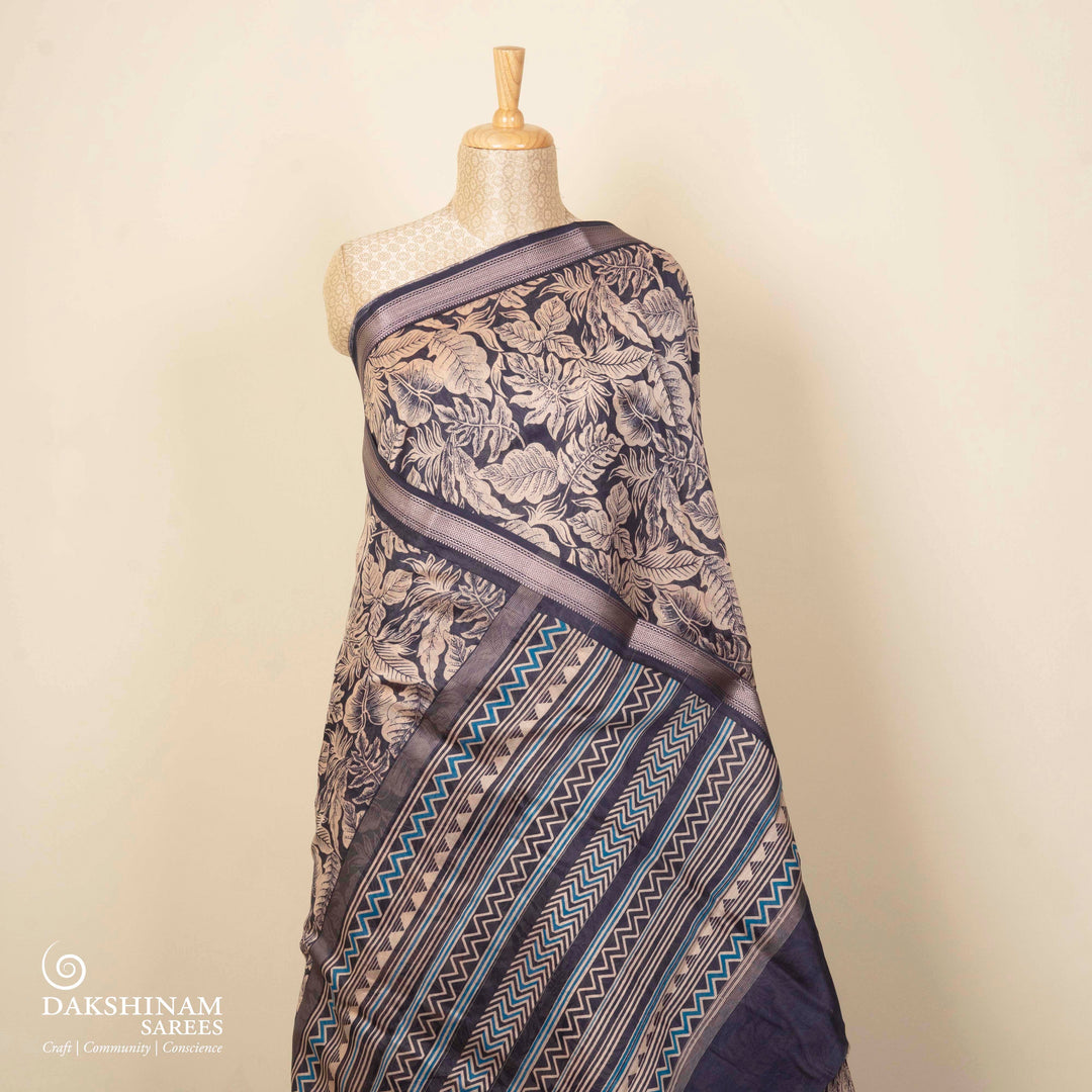 Dark blue Chanderi silk cotton saree with white leaf print, silver zari border and striped pallu