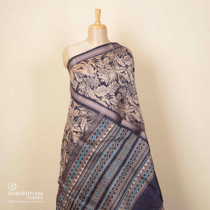 Dark blue Chanderi silk cotton saree with white leaf print, silver zari border and striped pallu