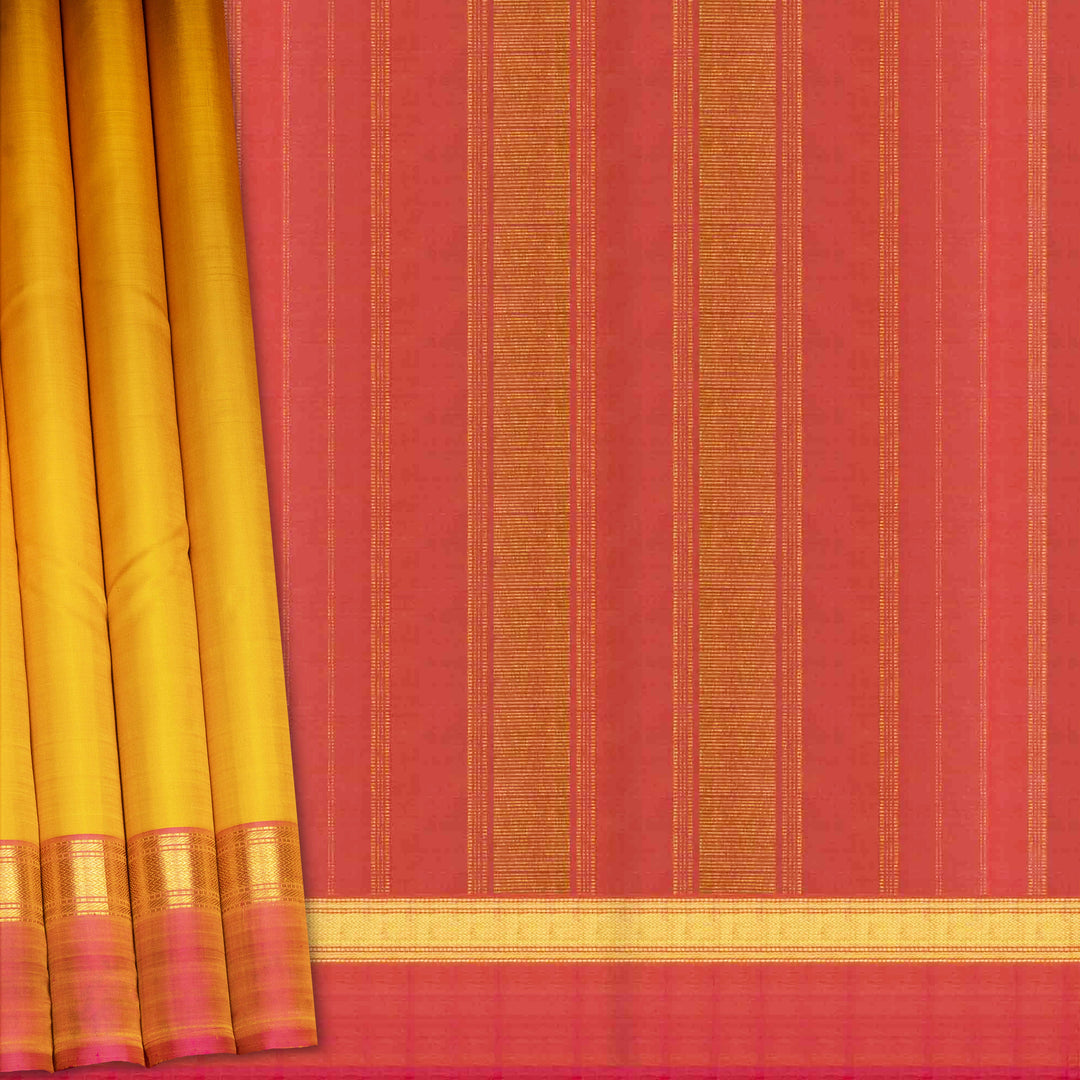 Yellow handwoven Kanjivaram silk saree with pink border, gold zari and contrast pallu