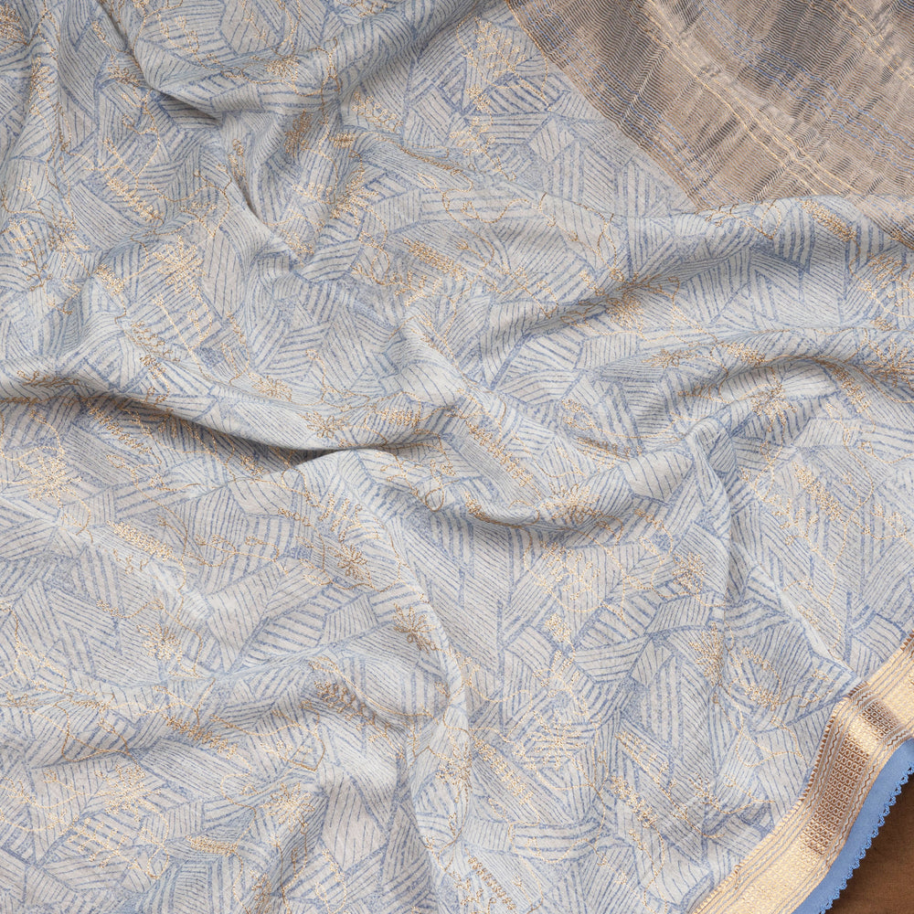 Ice blue Chanderi silk cotton saree with gold zari geometric patterns and embroidered lace border