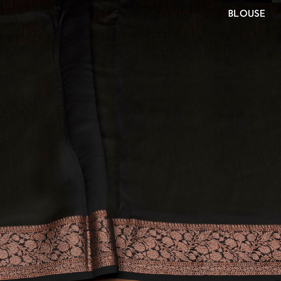 Black Chanderi silk cotton saree with white lotus floral print, gold zari border and orange striped pallu