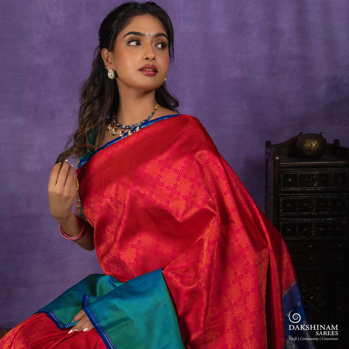 Orange no-zari Kanjivaram silk saree with light orange thread detailing, peacock green long border with silver zari lines, peacock blue pallu and matching blue blouse.