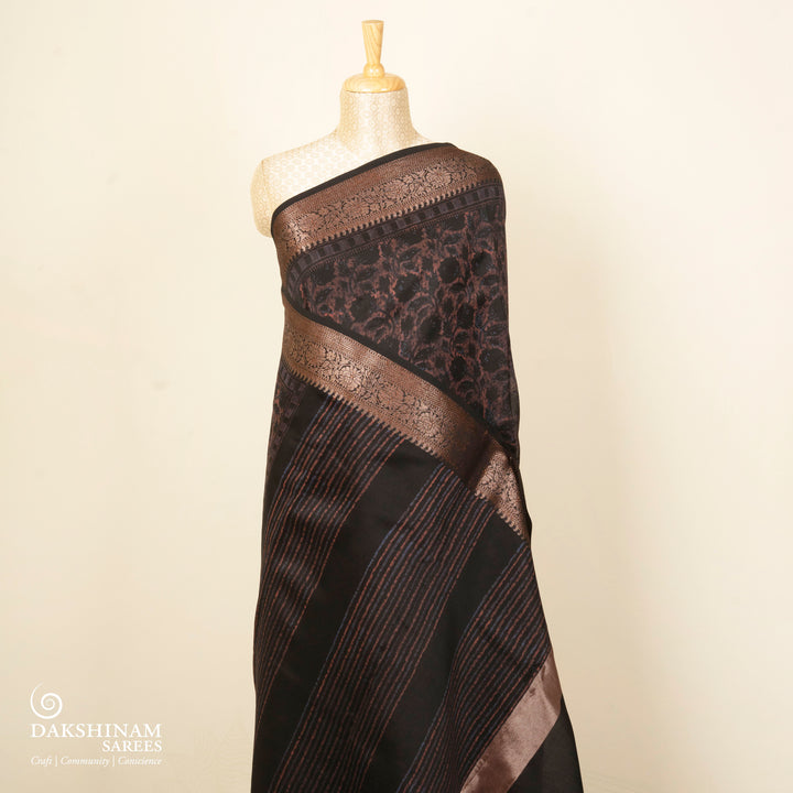 Black Chanderi silk cotton saree with white floral print, brown zari border and striped pallu