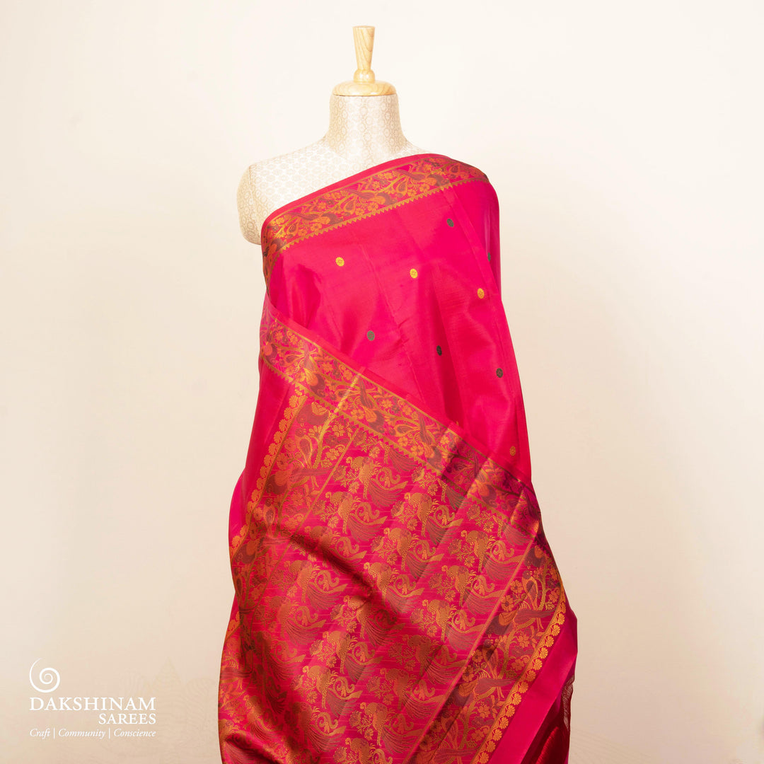 Pink handwoven Kanjivaram silk saree with parrot motifs, temple border and monotone pallu
