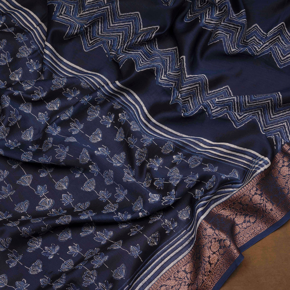 Dark blue Chanderi silk cotton saree with white lotus floral print, silver zari border and striped pallu