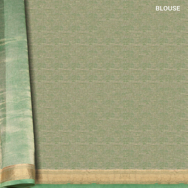 Green Chanderi silk cotton saree with gold zari geometric patterns and embroidered lace border